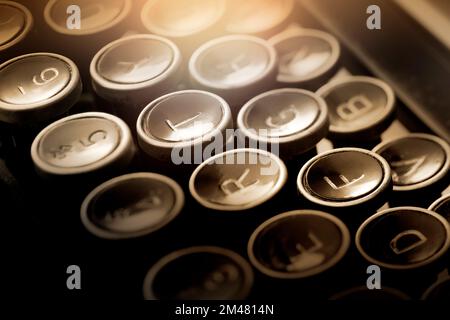 Shallow focus on close up view of ancient types keys. Warm light effect to give intimate ambience. Stock Photo