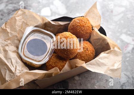 Meat beef balls, ingredients smoked beef, milk, flour, cheese filled with mozzarella. Served on paper dishes. Food for delivery. mockup for logo Stock Photo
