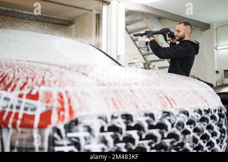 Pressure foam sprayer on car wash Stock Photo - Alamy