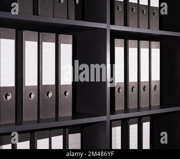 Folders binders, many documents organized in row on office shelf. High quality photo Stock Photo