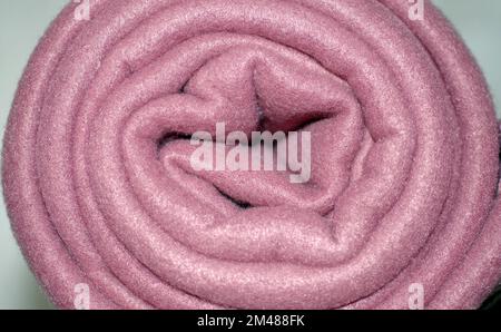 Background, structure, swirl; rolled up blanket in the shape of a snail Stock Photo