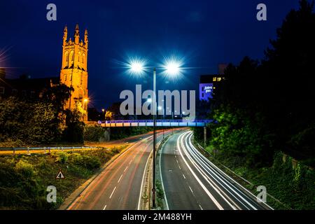 Night time in derby England with roads and st Marys church in the background and light trails Stock Photo