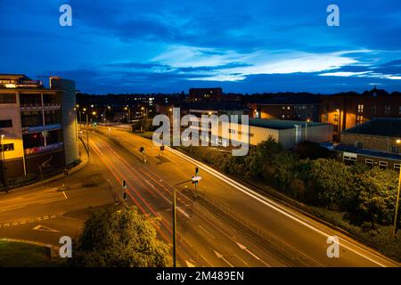 Night time in derby England with roads and st Marys church in the background and light trails Stock Photo