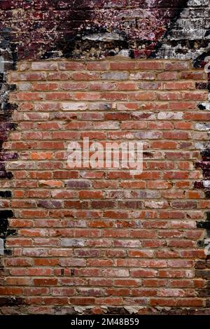 Cleaned up or patched old brick facade with paint and whitewash in surrounds. Stock Photo