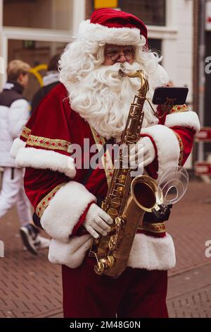 Santa claus playing the saxophone-Haarlem/Netherlands-11-12-2022-Christmas Market Stock Photo