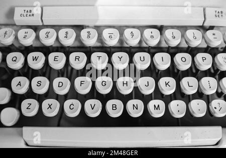 Writing machine. Close up photo of white vintage typewriter keys. Shot of keys on an antique typewriter. Nobody, selective focus, blurred Stock Photo