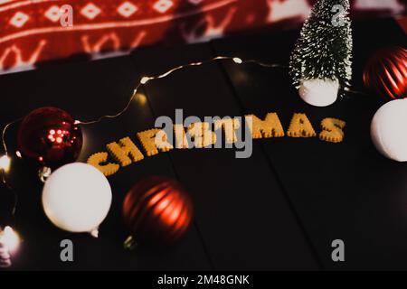 Gingerbread words Merry Christmas on old black table with Christmas decorations Stock Photo