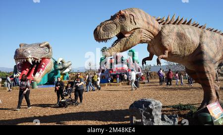 Woodland Hills, USA. 19th Dec, 2022. People visit an exhibition named 'Dinosaurs in the Valley' in Woodland Hills, California, the United States, on Dec. 18, 2022. A large-scale dinosaur exhibition is being held in Woodland Hills in Southern California, attracting visitors to interact with life-sized animated dinosaurs. Credit: Zeng Hui/Xinhua/Alamy Live News Stock Photo