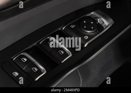 Driver door panel with buttons for lock car and lower windows Stock Photo