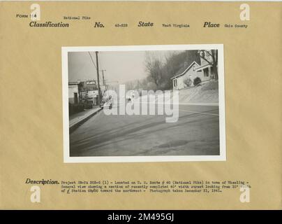 Route # 40 (National Pike) in Town of Wheeling. Original caption: Project SN-FA 203-G (1) - Located on U.S. Route # 40 (National Pike) in town of Wheeling. General view showing a section of recently completed 40' width street looking from 10' south of Station 69/50 toward the northwest - Photograph taken December 21, 1941. State: West Virginia Place: Ohio County. Stock Photo