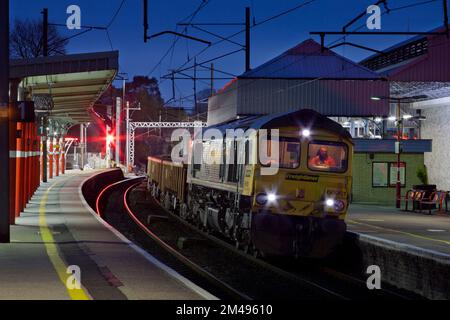 Freightliner class 66 diesel locomotive  at Oxenholme The lake District railway station in a engineers possession waiting while ballast is unloaded Stock Photo