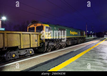 Freightliner class 66 diesel locomotive  at Oxenholme The lake District railway station in a engineers possession waiting while ballast is unloaded Stock Photo