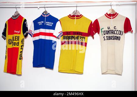 Cycling jerseys from different pro road cycling teams hanging.collection of cycle team jerseys Stock Photo