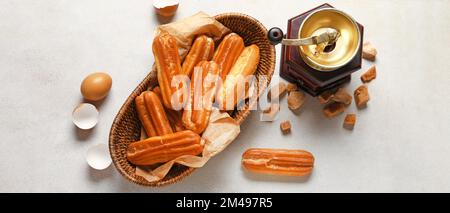 Composition with sweet eclairs on light background, top view Stock Photo