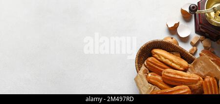 Composition with sweet eclairs on light background with space for text, top view Stock Photo
