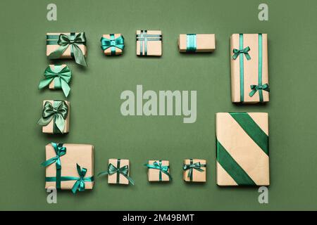 Frame made of different gift boxes on green background Stock Photo