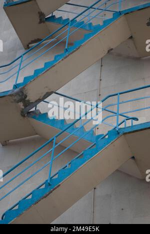 Fire escapes on a gray house wall. Stock Photo