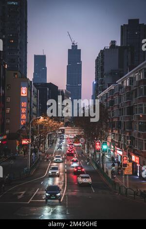 A vertical shot of cars, lights and architectures in a street of Tang Qiao district at the evening in Shanghai, China Stock Photo