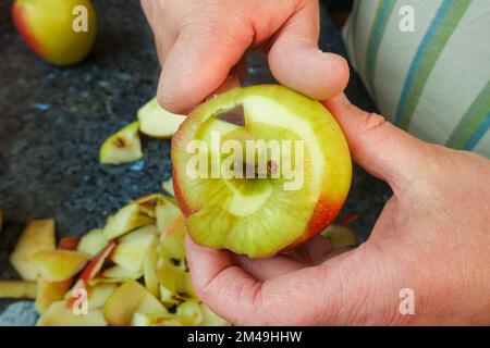 Swabian cuisine, preparing cider cake with apples, peeling apples, kitchen knife, Swabian baking speciality, from the oven, baked, sweet cake, apple Stock Photo