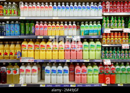 Bottles of Calpico milk-based soft drink on a supermarket shelf in an Asian grocery store. Stock Photo