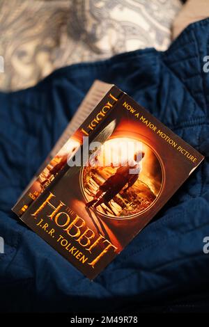 A selective focus shot of J. R. R. Tolkien's The Hobbit novel on a bed sheet in Poznan, Poland Stock Photo