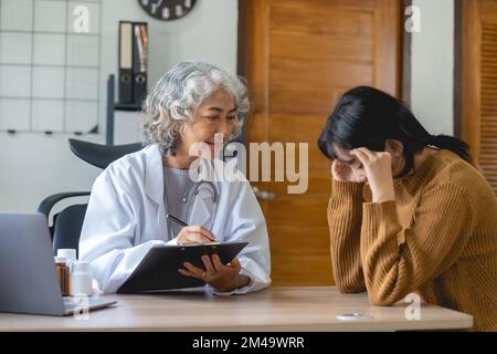 Senior doctor assisting a woman in her office. the patient is crying and feeling hopeless Stock Photo