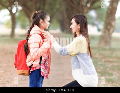 Mother comforting her daughter on the first day of school Stock Photo