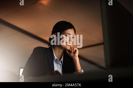 All night positivity, all night productivity. a young businesswoman working online during a late night in a modern office. Stock Photo