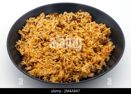 Basmati Rice with bolognese sauce in a black dish. Stock Photo