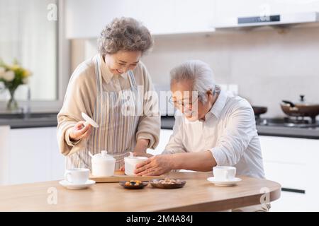 Happy senior Chinese couple having breakfast Stock Photo