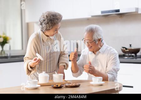 Happy senior Chinese couple having breakfast Stock Photo