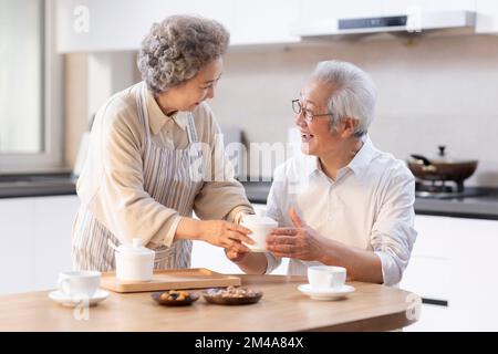 Happy senior Chinese couple having breakfast Stock Photo