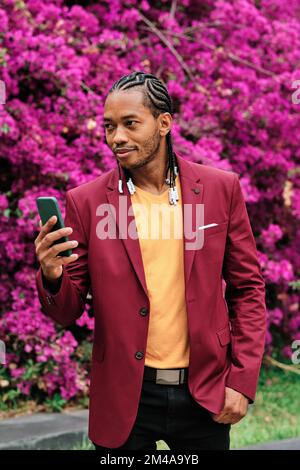 Handsome african stylish man using a mobile outdoors Stock Photo