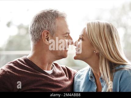 As gorgeous as the day I married you. an affectionate mature couple sharing a romantic moment at home. Stock Photo
