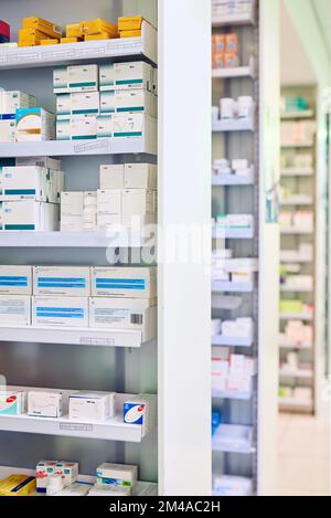 We stock only the best. shelves stocked with various medicinal products in a pharmacy. Stock Photo