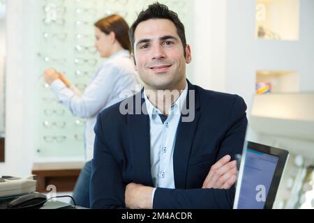 happy businessman in an opticians wearing a suit Stock Photo