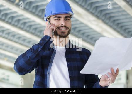 architect inside house being renovated talking on cellphone Stock Photo