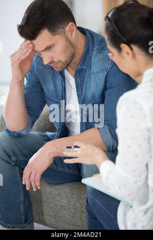 man discussing couple problems with relationship counselor Stock Photo