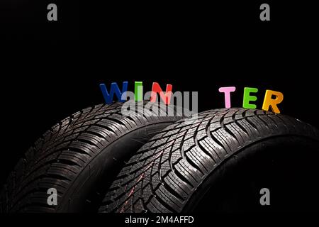 Winter Car tire for snow isolated on white background with copy space for text.  New automobile tyre. Stock Photo