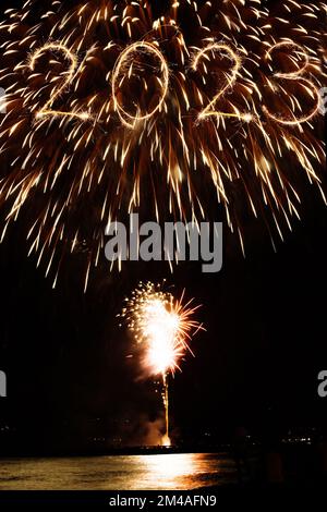 2023 new year coming written with sparkler and fireworks illuminationas a background Stock Photo