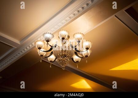 chandelier in a dark room on the wall included Stock Photo