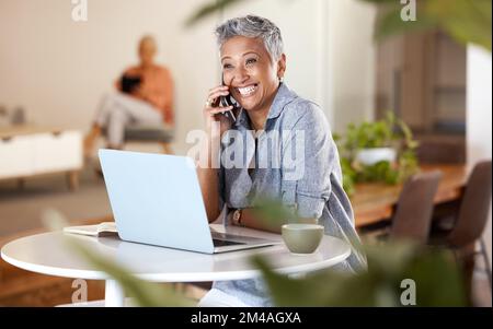 Cafe, phone call and senior woman talking, chatting or speaking. Remote worker, freelancer and happy elderly female in coffee shop with laptop and Stock Photo
