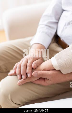 Senior Chinese couple holding hands Stock Photo