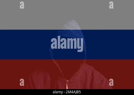 Double exposure of Russian flag and Anonymous person in hood. Stock Photo