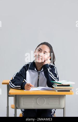 Chinese student thinking in classroom Stock Photo