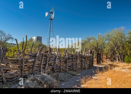 Windmill, water tank, wattle fence at corral, Bates Well Ranch, El Camino del Diablo, Organ Pipe Cactus National Monument, Arizona, USA Stock Photo