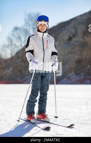 Young Chinese man skiing in ski resort Stock Photo