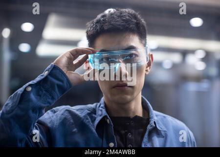 Young Chinese man wearing futuristic glasses Stock Photo