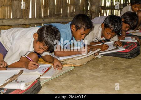 Children in the government school in Borbil still study on the floor Stock Photo