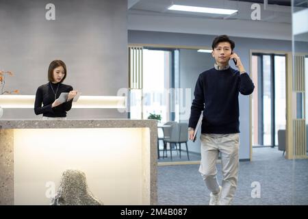 Young Chinese businessman talking on the phone Stock Photo